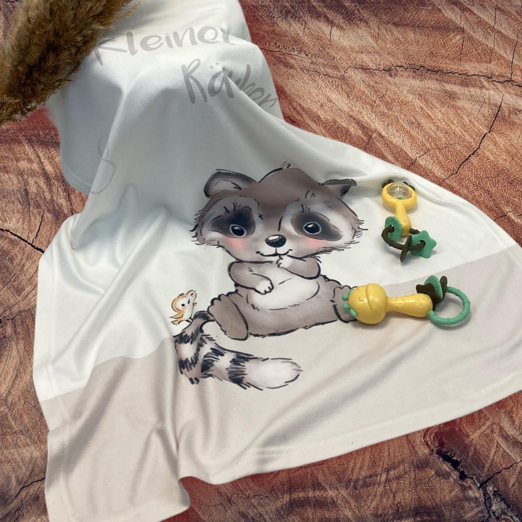 Decke Waschbär auf dem Boden mit Spielzeug