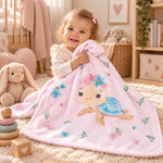Mädchen kuschelt mit rosa Babydecke mit Schildkrötenmotiv im Kinderzimmer