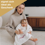 Kind mit personalisierter Flauschdecke sitzt auf Mamas Schoß